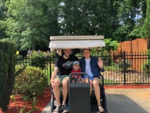 Tolik, Alyona and Roman on the golf cart