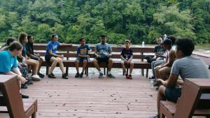 Youth Group Leo teaching next to flowing river