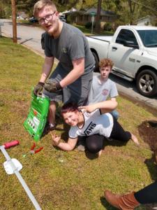 Youth cleanup Philip, Molly and Cole cutting up
